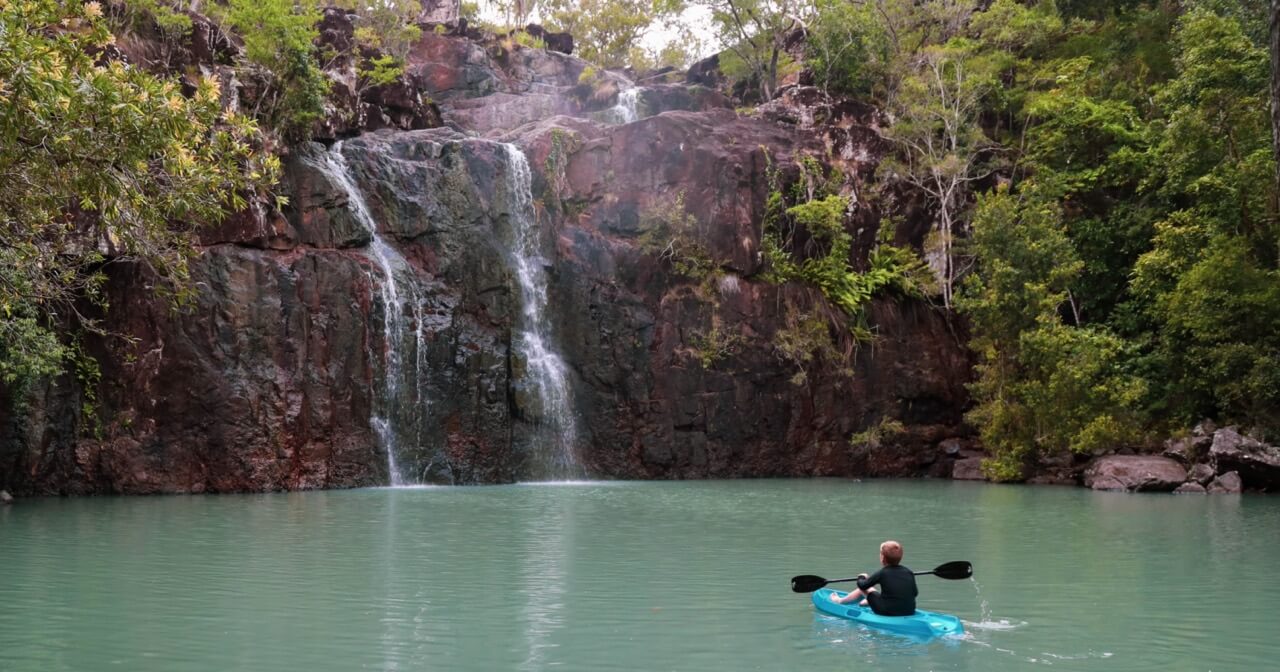 Discover the best waterfalls in Queensland for your next family adventure. On photo: Cedar Creek Falls near Arlie Beach.